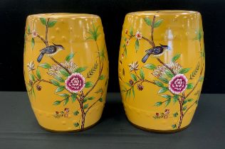 A pair of Chinese inspired yellow barrel stools, decorated with flowers and birds, 45cm high (2)