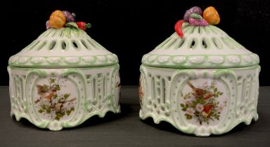 A pair of porcelain lidded fruit top jars decorated with print of birds and moulded lid of fruit and