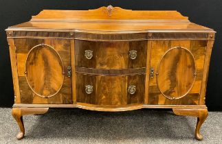 A 19th century style reproduction walnut sideboard, shaped quarter galleried back, break-front