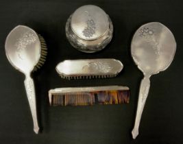 A silver backed dressing table vanity set, hand mirror, clothes and hair brushes, tortoiseshell