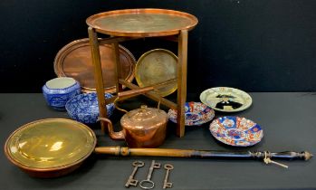 A 19th century oval copper kettle, tray table, warming pan, three 18th/19th century cast iron