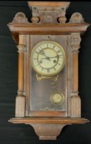 A Hamburg American Clock Company (HAC) Walnut cased Vienna wall clock, white enamel dial, black