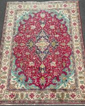 A North West Persian Heriz Carpet, hand-knotted in tones of red, deep blue, turquoise, and cream,