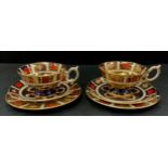 A pair of Royal Crown Derby 1128 ‘Old Imari’ tea cup trios, cups, saucers and side plated, 8cm high,