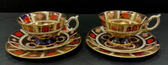 A pair of Royal Crown Derby 1128 ‘Old Imari’ tea cup trios, cups, saucers and side plated, 8cm high,