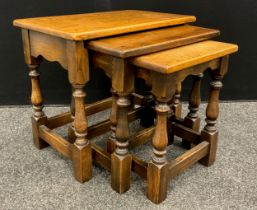 A nest of three Titchmarsh and Goodwin style oak tables, the largest measuring 48cm high x 55cm x