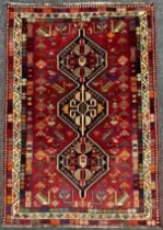 A South West Persian Qashgai rug, hand-knotted with a row of three hexagonal-shaped medallions