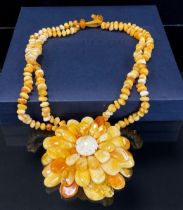 A C W Sellers copal amber flowerhead pendant necklace, composed of forty six individual petals