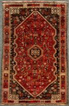 A South West Persian Qashgai Carpet, hand-knotted in deep tones of red, grey, blue, and green, the
