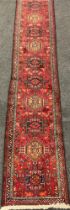 An Indian ‘Gharade’ region hand-knotted runner carpet, 366cm x 75cm.