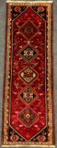 A South West Persian Qashgai runner carpet, hand-knotted in rich tones of red, black, blue, and