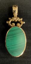 A 9ct gold mounted oval seal pendant, with malachite and carnelian panels, Sheffield 1978, 16.4g