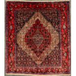 A North West Persian Senneh rug / carpet, hand-knotted with concentric diamond-shaped medallions