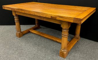 An oak plank-top refectory dining table, by Brampton Furniture, extendable draw-leaves, turned