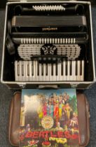 A black Scarlatti Accordion, cased,40cm long