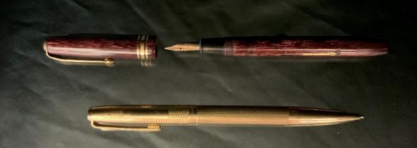 A 9ct gold cased Yard-o-lead ball point pen, E Baker & Son Birmingham 1973, 25.1g gross; a Conway