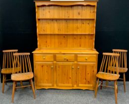 A pine dresser, two tier plate-rack top above three short drawers and three cupboard doors, 185.