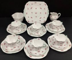 A Shelley ‘Rosebud’, pattern 13545 tea service for six comprised of; a picnic plate, so tea ups