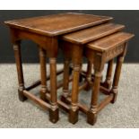 An Old Charm style nest of three oak tables, the largest measuring 53.5cm high x 58.5cm x 38.5cm.