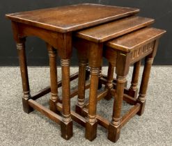 An Old Charm style nest of three oak tables, the largest measuring 53.5cm high x 58.5cm x 38.5cm.