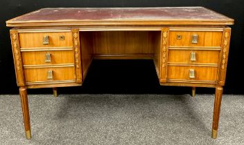 A French walnut writing desk, in the Louis XVI style, with inverted bow-front rectangular top, inset