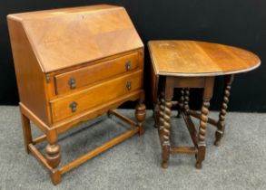 A 1930’s oak bureau, 99cm high x 76cm wide x 44cm deep; and a 1930’s oval-top drop-leaf table,