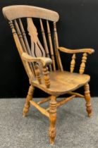 A Late Victorian elm and beech armchair, lyre and spindle-back, double H-stretcher, turned legs,