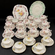 Tea ware including; twelve floral and gild tea cups and saucers, conforming picnic plate, sugar bowl