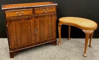 A small mahogany side cabinet, having a pair of short drawers to frieze, above two cupboard doors,