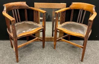 A pair of early 20th century oak Smoker’s Bow armchairs, serpentine shaped fronts, leatherette