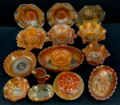 A quantity of carnival glass including bowls, plates and lidded pots: etc