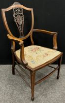 An Edwardian ‘Hepplewhite’ style walnut armchair, shied-shaped back with carved splat, tapestry