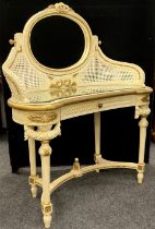 A Louis XVI style dressing table, the oval tilting mirror supported by gracefully down-curved