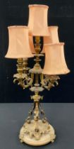 A gilt metal five light table lamp, as a candelabra, with central taller light, surrounded by four