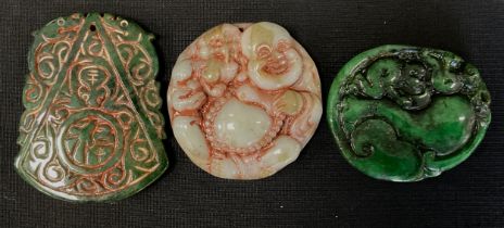 Three Chinese and Japanese tablet pendants, in multi tone green jade colours, as Hotei etc (3)