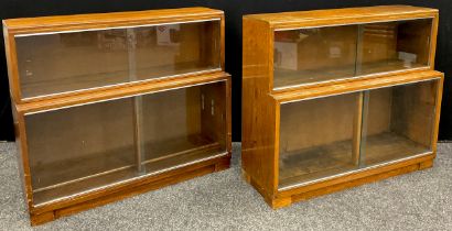 A ‘Minty’ oak two-tier bookcase with sliding glass doors; and a matching ‘Minty’ bookcase in walnut,