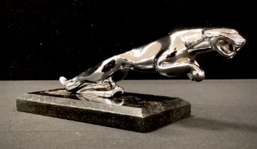 A replica silver coloured car mascot as a Jaguar on black marble plinth, 15cm long