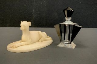 A carved alabaster figure as a recumbent Greyhound, oval plinth, 15.7cm long; an Art Deco style