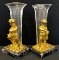 A pair of gilt metal and glass figural spill vases, as Bacchanalian figures holding Masks, stood