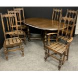 An Ercol Elm extending dining table, with set of six Ercol ‘Old Colonial’ design chairs, inc. pair