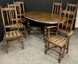 An Ercol Elm extending dining table, with set of six Ercol ‘Old Colonial’ design chairs, inc. pair