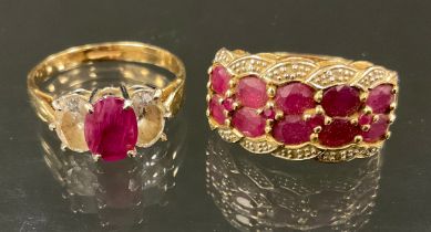 A ruby and diamond cluster ring, with two rows of five oval cut pinky red rubies, between diamond