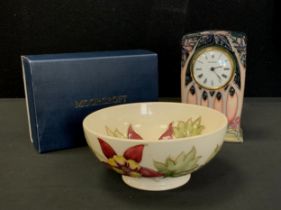 A Moorcroft pottery Cluny pattern mantel clock, 16cm high, boxed with sleeve; a Columbine pattern