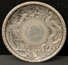 A Chinese white metal coin dish, 9.5cm diameter