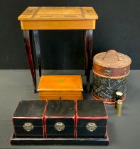 Boxes & Objects - A set of three Japanese cinnabar coloured and black caddies or boxes with stand;