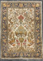 A Persian silk and wool mix rug / carpet, the field knotted with Tree of Life and exotic birds,