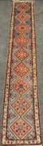 A North West Persian Rudbar Runner carpet, hand-knotted with a row of nine diamond-shaped