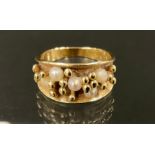 Style of Karlheinz Sauer (Bn 1943 Germany) a 9ct gold seed pearl ring, with tapering stylised crest.