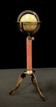 A miniature terrestrial globe on tri-pod stand, 29cm high