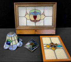 An Art Nouveau stained glass light fitting panel, stained pine box mount, others stained and